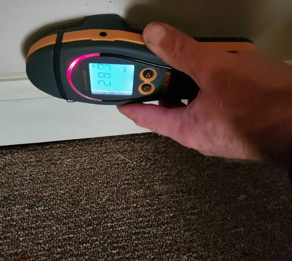 Moisture detection at baseboard during Storm Damage Restoration in Farmville